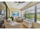 Cozy sun room filled with wicker furniture, offering a relaxing space with natural light and outdoor views at 7923 Radcliffe Cir, Port Richey, FL 34668