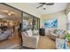Relaxing sunroom with wicker furniture, natural light, and a view into the living area, perfect for relaxation at 7923 Radcliffe Cir, Port Richey, FL 34668