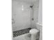 Modern bathroom featuring a walk-in shower with rainfall shower head and hexagon mosaic flooring at 8602 Huron Court # 47, Tampa, FL 33614