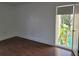 Bedroom with hardwood flooring and a large window overlooking the pool and foliage at 8602 Huron Court # 47, Tampa, FL 33614