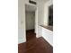 Hallway leading to kitchen area with hardwood flooring at 8602 Huron Court # 47, Tampa, FL 33614
