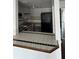 Eat-in kitchen with black and white backsplash and view to living area at 8602 Huron Court # 47, Tampa, FL 33614