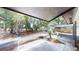 Open carport area with mature trees and a spacious backyard at 9218 Memorial Hwy, Tampa, FL 33615
