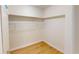 Walk-in closet featuring wood floors, wire shelving, and freshly painted walls at 9218 Memorial Hwy, Tampa, FL 33615