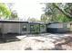 Charming single-story home with gray and white trim, covered front porch, and well-manicured lawn at 9218 Memorial Hwy, Tampa, FL 33615