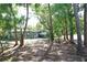 A view of the front exterior of the home surrounded by mature trees and lush landscaping at 9218 Memorial Hwy, Tampa, FL 33615