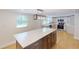 Open-concept kitchen with island, white cabinets, and modern lighting at 9218 Memorial Hwy, Tampa, FL 33615