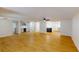 Spacious living room featuring light wood floors, a ceiling fan, and a view of kitchen at 9218 Memorial Hwy, Tampa, FL 33615