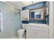 Cozy bathroom featuring a shower, toilet, vanity with a framed mirror, and a medicine cabinet for storage at 9309 120Th St, Seminole, FL 33772