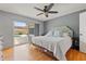 The main bedroom features laminate floors, ceiling fan, and access to the pool area at 9309 120Th St, Seminole, FL 33772