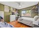 A bedroom with posters on the walls, wood floors and a ceiling fan at 9309 120Th St, Seminole, FL 33772