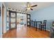 Dining area featuring a stylish ceiling fan, barn doors, and natural light at 9309 120Th St, Seminole, FL 33772