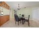 Dining room featuring a glass table, chandelier and direct access to the kitchen at 9309 120Th St, Seminole, FL 33772