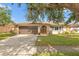 Charming home featuring stone accents, a well-maintained lawn, and a double door entryway at 9309 120Th St, Seminole, FL 33772