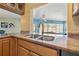 A close up on the granite kitchen countertop with stainless steel sink and wood cabinets at 9309 120Th St, Seminole, FL 33772