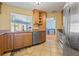 The kitchen features stainless steel appliances, tile floor and wood cabinets at 9309 120Th St, Seminole, FL 33772