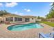 A kidney-shaped pool surrounded by brick pavers provides a relaxing outdoor space with access to the house at 9309 120Th St, Seminole, FL 33772