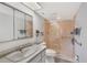 Well-lit bathroom featuring a glass-enclosed shower, vanity with marble countertop, and mirrored medicine cabinet at 9461 Harbor Greens Way # 502, Seminole, FL 33776