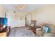 Cozy bedroom with a ceiling fan, carpet, and a view of an ensuite bathroom through an open doorway at 9461 Harbor Greens Way # 502, Seminole, FL 33776