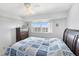 Bedroom with natural light, light wood floors, neutral paint, and ceiling fan at 9461 Harbor Greens Way # 502, Seminole, FL 33776