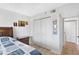 Bedroom features closet space, natural light, light wood floors, and neutral paint at 9461 Harbor Greens Way # 502, Seminole, FL 33776