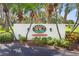 Harbor Greens entrance sign amidst lush greenery, marking a private residential community at 9461 Harbor Greens Way # 502, Seminole, FL 33776