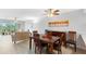 Open-concept living and dining area with plenty of natural light, wood floors, and neutral paint at 9461 Harbor Greens Way # 502, Seminole, FL 33776