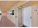 Condo entryway featuring a secured door with storm door and unit number 502 at 9461 Harbor Greens Way # 502, Seminole, FL 33776