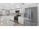 Modern kitchen featuring stainless steel appliances, white cabinetry, and light countertops at 9461 Harbor Greens Way # 502, Seminole, FL 33776