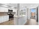 Modern kitchen featuring white cabinets, stainless steel appliances, and an open layout at 9461 Harbor Greens Way # 502, Seminole, FL 33776