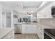 Bright kitchen featuring stainless steel appliances, white cabinetry, and an open design at 9461 Harbor Greens Way # 502, Seminole, FL 33776
