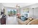 Bright living room featuring neutral furniture, a ceiling fan, and sliding doors to the balcony at 9461 Harbor Greens Way # 502, Seminole, FL 33776