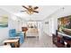 Open-concept living area featuring wood-look floors, comfortable seating, and view of the kitchen at 9461 Harbor Greens Way # 502, Seminole, FL 33776