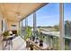 Enclosed balcony featuring a variety of plants and furniture, with neighborhood views in the background at 9461 Harbor Greens Way # 502, Seminole, FL 33776