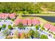 Aerial view of townhomes, parking area, and a serene pond surrounded by lush greenery at 9481 Highland Oak Dr # 1310, Tampa, FL 33647