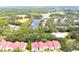 Stunning aerial view of townhomes with red roofs near a lake and green landscape at 9481 Highland Oak Dr # 1310, Tampa, FL 33647