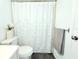 Bright bathroom shows toilet, floral shower curtain, and towel rack at 9481 Highland Oak Dr # 1310, Tampa, FL 33647
