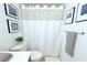 Cozy bathroom featuring a shower with a curtain, framed artwork, and a gray towel at 9481 Highland Oak Dr # 1310, Tampa, FL 33647