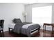 Bright bedroom with wood floors features a window offering natural light and neutral wall paint at 9481 Highland Oak Dr # 1310, Tampa, FL 33647
