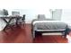 Bright bedroom with wood floors shows computer desk, large window, and neutral wall paint at 9481 Highland Oak Dr # 1310, Tampa, FL 33647