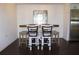 Stylish dining area with seating for four, featuring modern decor and stainless steel refrigerator at 9481 Highland Oak Dr # 1310, Tampa, FL 33647