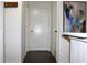 Clean hallway, a transition space with light walls and dark floor, leading to other rooms at 9481 Highland Oak Dr # 1310, Tampa, FL 33647