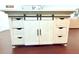 Custom kitchen island featuring drawers and sliding doors, great for storage or a coffee bar at 9481 Highland Oak Dr # 1310, Tampa, FL 33647