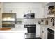 Bright kitchen with white cabinets, stainless steel appliances, and modern tile backsplash at 9481 Highland Oak Dr # 1310, Tampa, FL 33647
