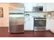 Kitchen featuring stainless steel appliances including a refrigerator, stove, and microwave at 9481 Highland Oak Dr # 1310, Tampa, FL 33647