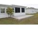View of the patio with the enclosed Florida room behind it at 9705 45Th N Way, Pinellas Park, FL 33782