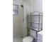 A white bathroom featuring a shower, toilet with shelving, and a window for natural light at 9705 45Th N Way, Pinellas Park, FL 33782