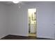 A bedroom opens to a bathroom with white cabinets, and an oval mirror at 9705 45Th N Way, Pinellas Park, FL 33782
