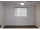 A well-lit bedroom features a ceiling fan, a window with blinds, and dark wood floors at 9705 45Th N Way, Pinellas Park, FL 33782