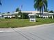 Community clubhouse with lush landscaping and clear signage with event announcements at 9705 45Th N Way, Pinellas Park, FL 33782